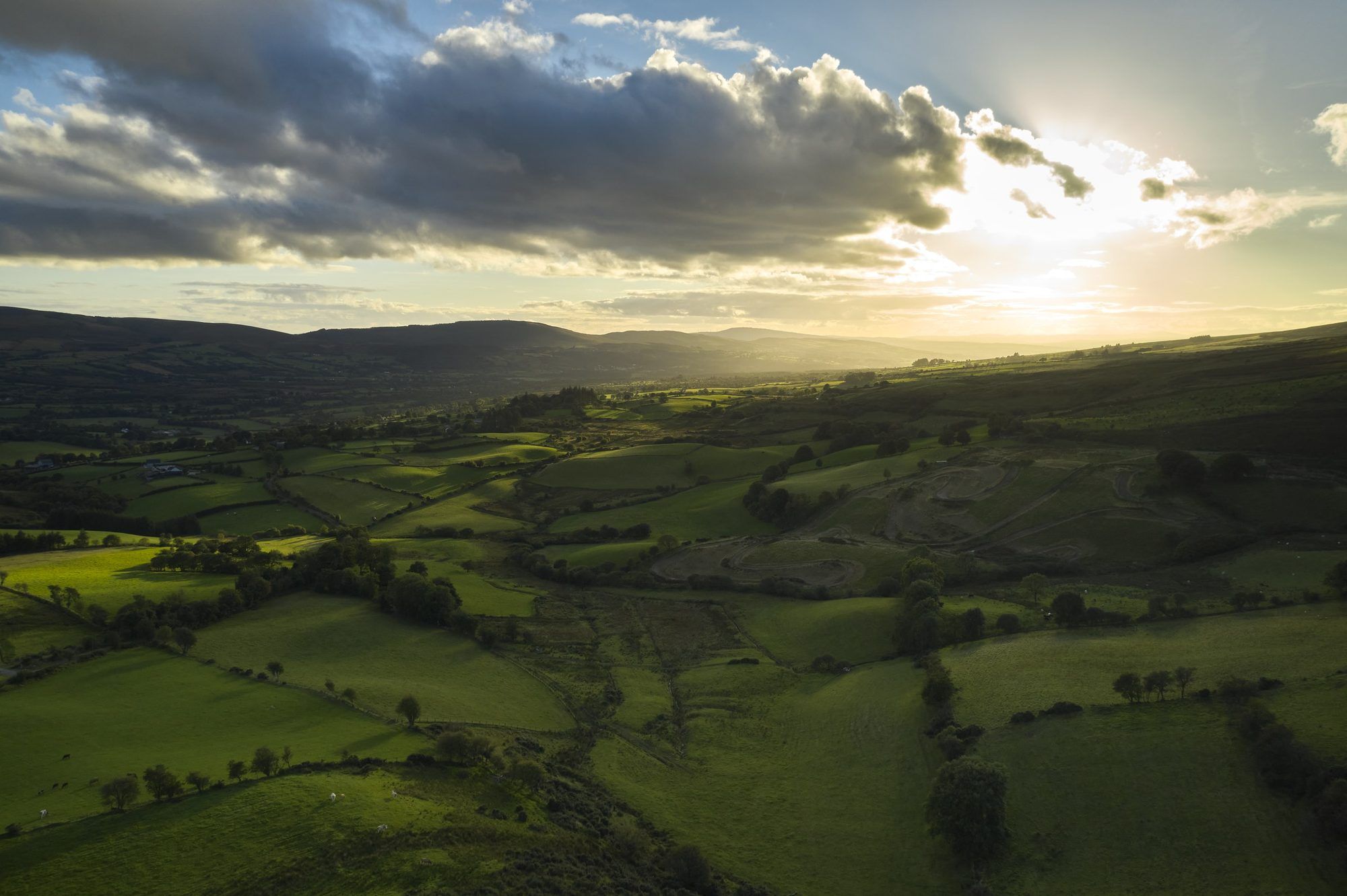 Sunset over green fields and the Sperrin Mountains near Plumbridge